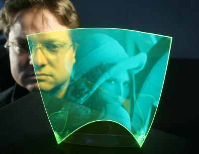 This shows the world's first flexible and completely transparent image sensor. The plastic film is coated with fluorescent particles. Credit: Optics Express.