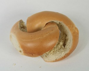 After being cut, the two halves can be moved but are still linked together, each passing through the hole of the other.   (So when you buy your bagels, pick ones with the biggest holes.) [downloaded from http://georgehart.com/bagel/bagel.html]
