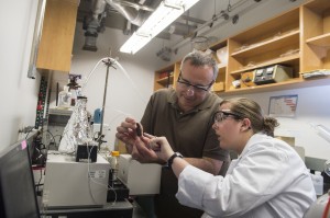 Rice University chemist Andrew Barron and graduate student Brittany Oliva-Chatelain investigate the prototype of a device that allows for rapid testing of nanotracers for the evaluation of wells subject to hydraulic fracturing. (Credit: Jeff Fitlow/Rice University)