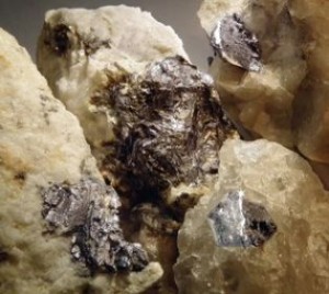 Molybdenum disulfide occurs in nature as molybdenite, crystalline material that frequently takes the characteristic form of silver-colored hexagonal plates. (Source: FUW)