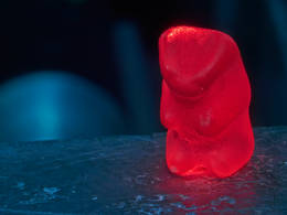 Gummy bear on the experimental set-up – To avoid influences of the colour, the scientists only examined red gummy bears using positrons. Photo: Wenzel Schürmann / TUM