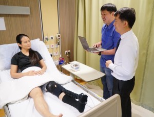  Caption: NUS researchers (from right to left) Assistant Professor Raye Yeow, Mr Low Fanzhe and Dr Liu Yuchun demonstrating the novel bio-inspired robotic sock. Credit: National University of Singapore