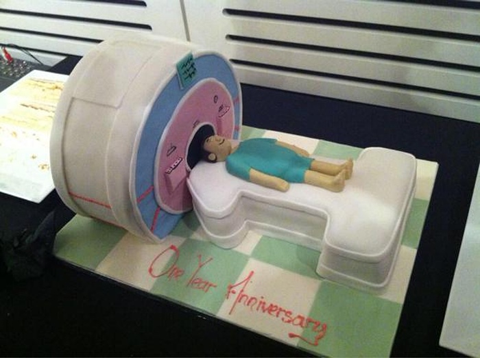 A cake shaped like a subject entering an MRI scanner for @ImanovaImaging’s 1st birthday party. Because why not? Photograph: @M_Wall