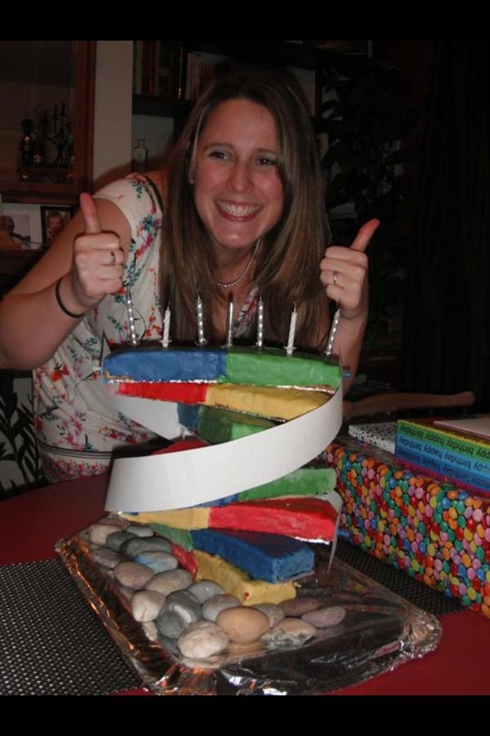 Katie Grifiths, posing with a DNA cake made by her sister Emma. What’s with these biology-themed cakes and their ability to overrule gravity? Do NASA know about this? Photograph: Katie Griffiths