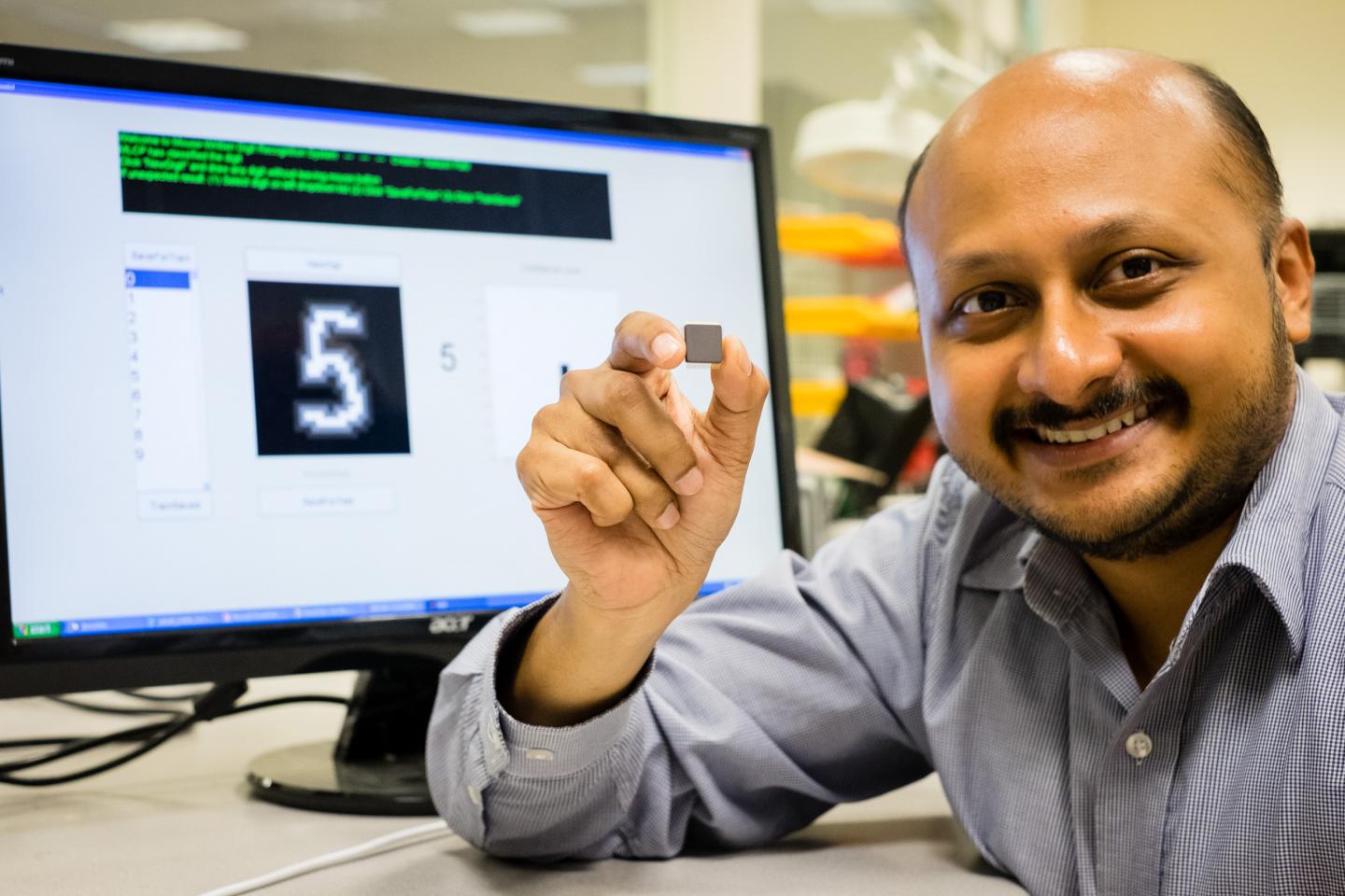 Caption: NTU Asst Prof Arindam Basu is holding his low-powered smart chip. Credit: NTU Singapore